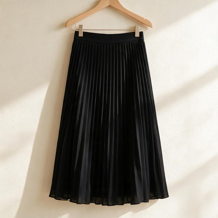 Ponsonby Lane pleated midi skirt in Black – hanging on a wooden hanger